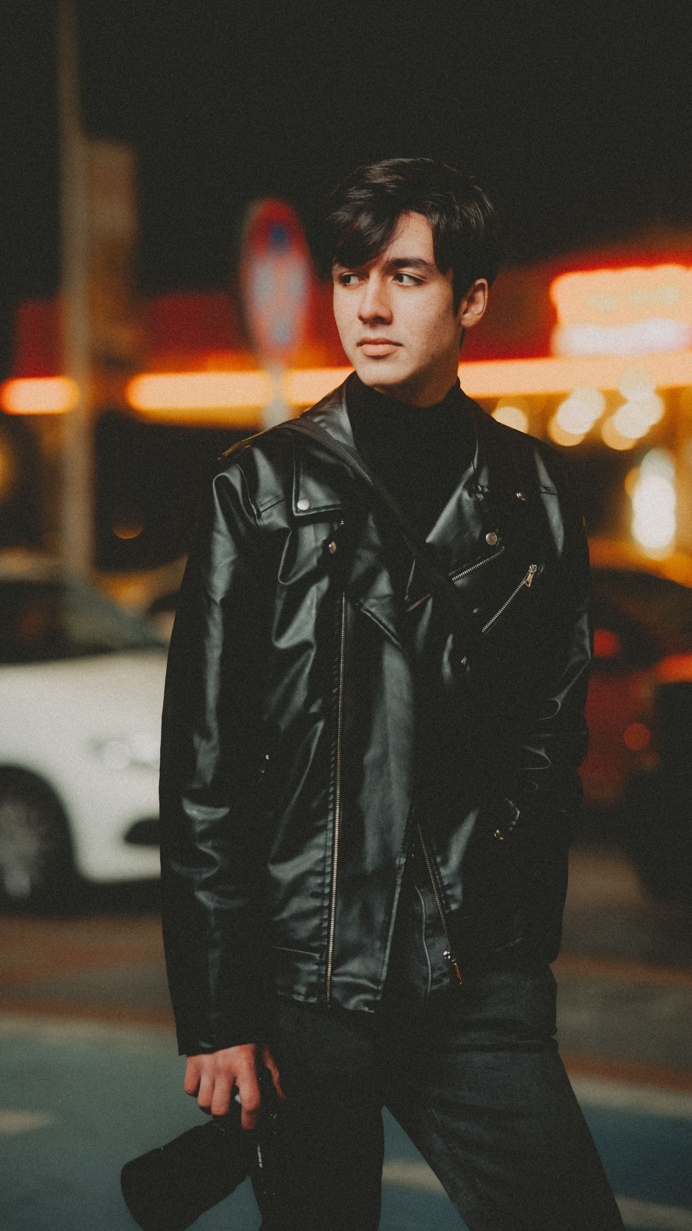Man in leather jacket at night