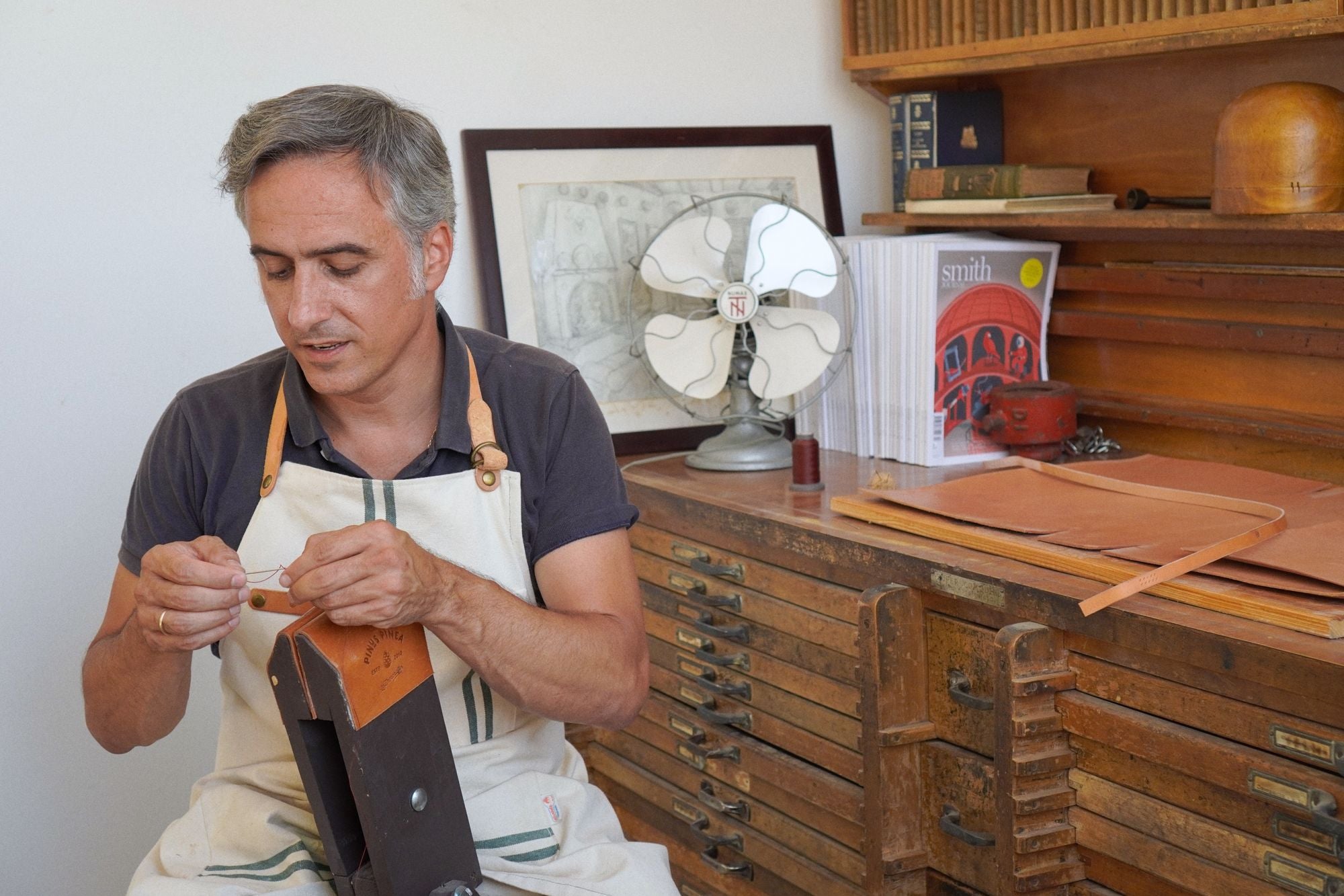 Artisan handcrafting leather goods in a workshop