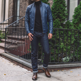 Men's blue faux leather biker jacket with quilted shoulders, full-length lifestyle view