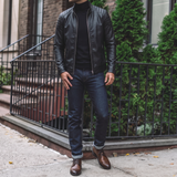 Men's black faux leather biker jacket with quilted shoulders, full-length lifestyle view