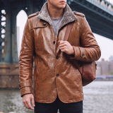 Men's reddish brown faux leather coat, lifestyle view with shoulder bag