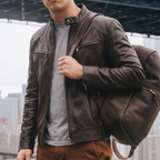 Men's brown faux leather racer jacket, lifestyle view with shoulder bag