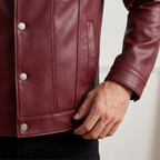 Men's burgundy button-front faux leather trucker jacket, cuff and hem detail