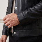 Men's black button-front faux leather trucker jacket, cuff and hem detail