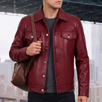 Men's burgundy button-front faux leather trucker jacket, lifestyle view with shoulder bag