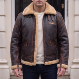 Men's brown faux leather aviator jacket with plush trim, front lifestyle view