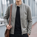 Men's gray minimalist faux leather racer jacket, lifestyle view with shoulder bag