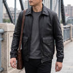 Men's black leather A2 flight jacket, lifestyle view with shoulder bag