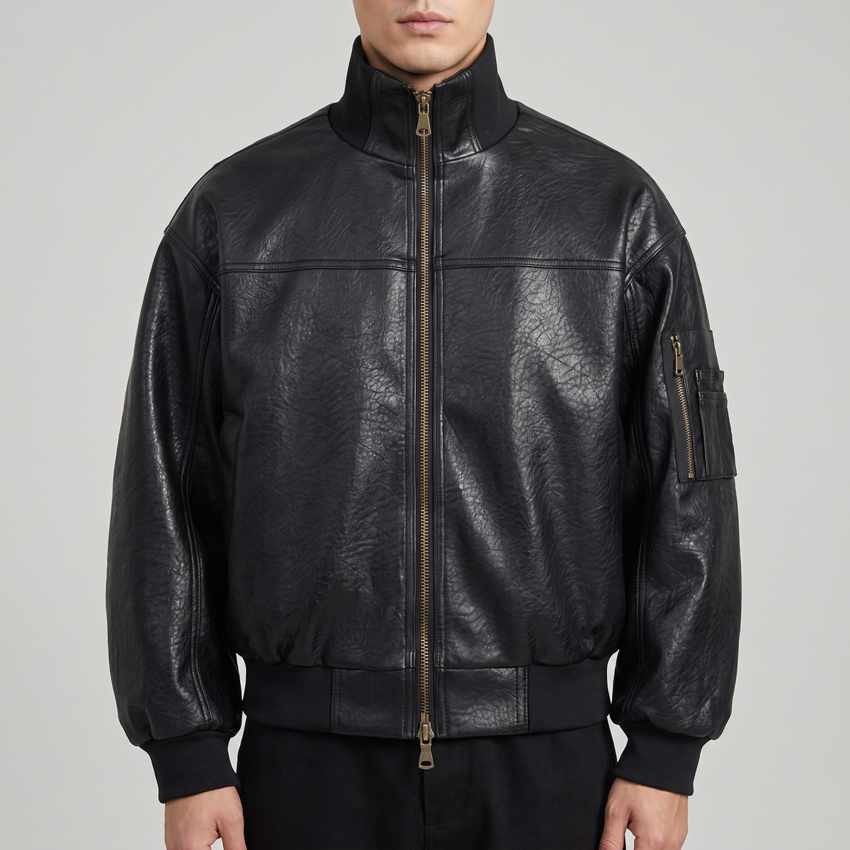 Men's black textured faux leather bomber jacket, studio front view