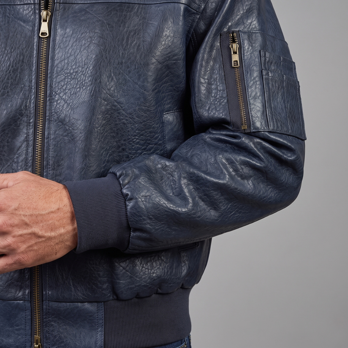 Men's dark blue textured faux leather bomber jacket, cuff and sleeve pocket detail