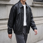 Men's black relaxed faux leather bomber jacket, three-quarter lifestyle view