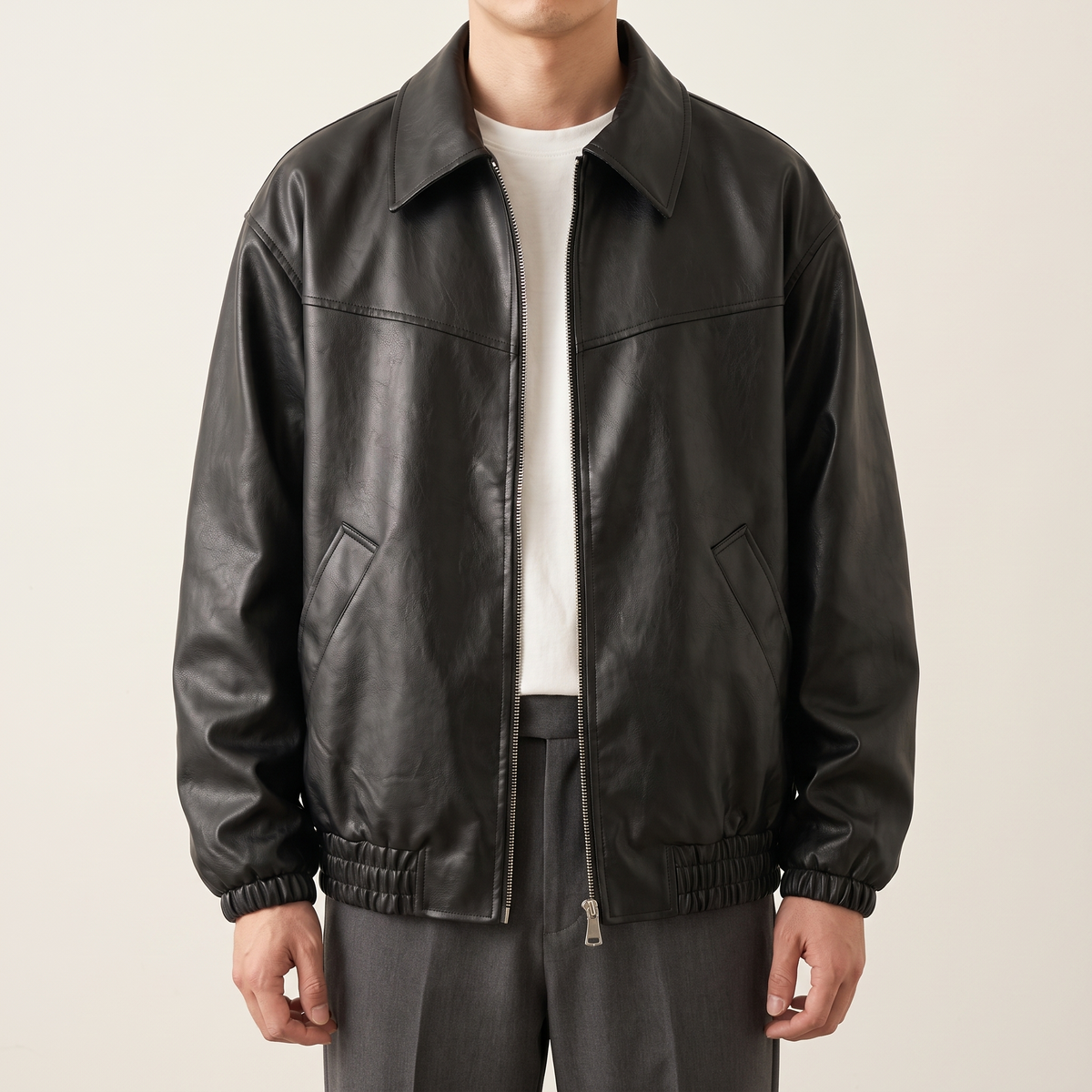 Men's black relaxed faux leather bomber jacket, studio front view