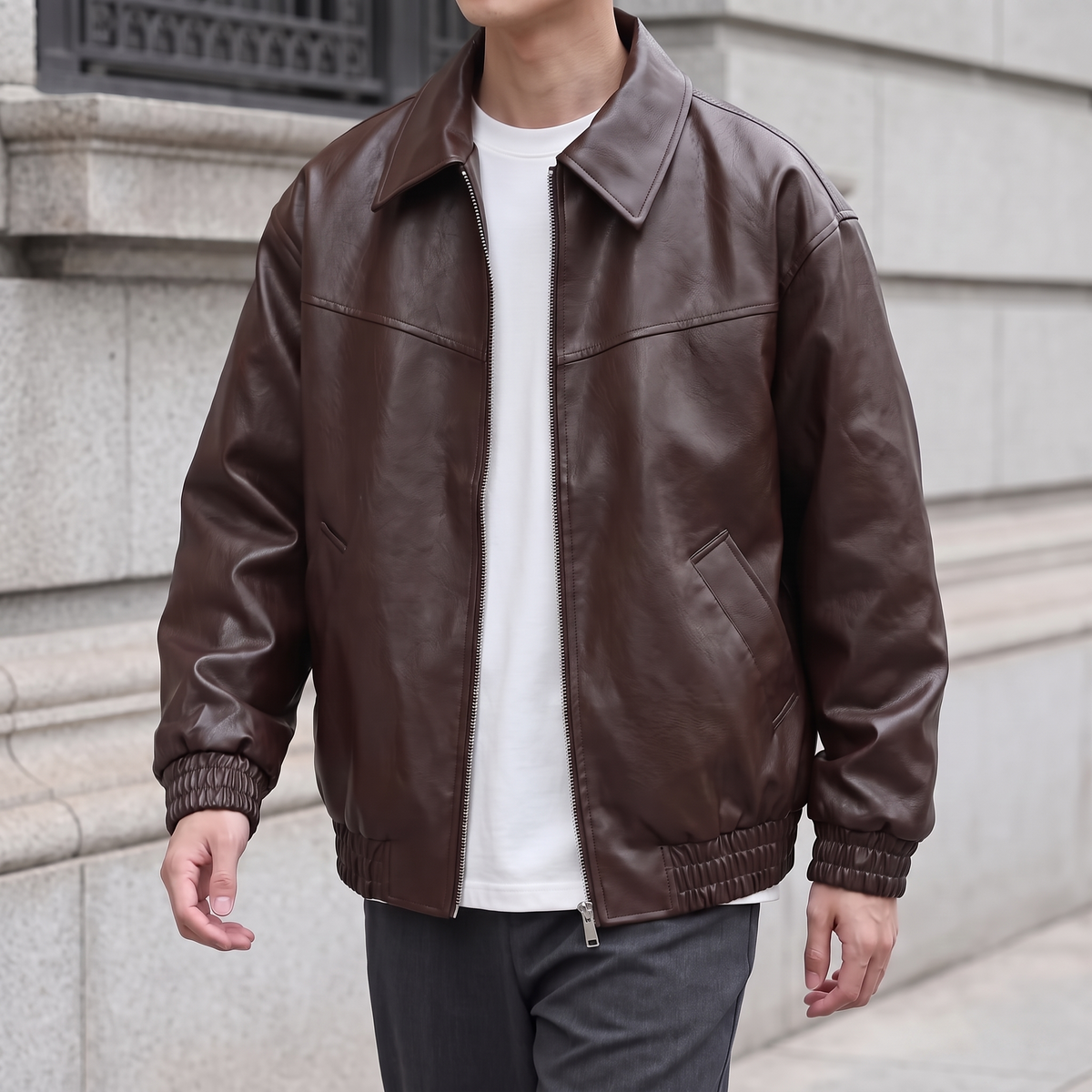 Men's brown relaxed faux leather bomber jacket, three-quarter lifestyle view