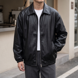 Men's black oversized faux leather jacket, street lifestyle view