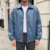 Men's blue oversized faux leather jacket, front lifestyle view