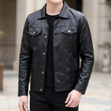 Men's black slim faux leather trucker jacket, three-quarter lifestyle view