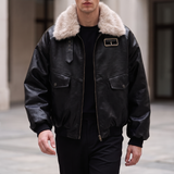 Men's black faux leather aviator jacket with faux fur collar, walking lifestyle view