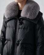 Padded jacket in Black, textured collar detail.