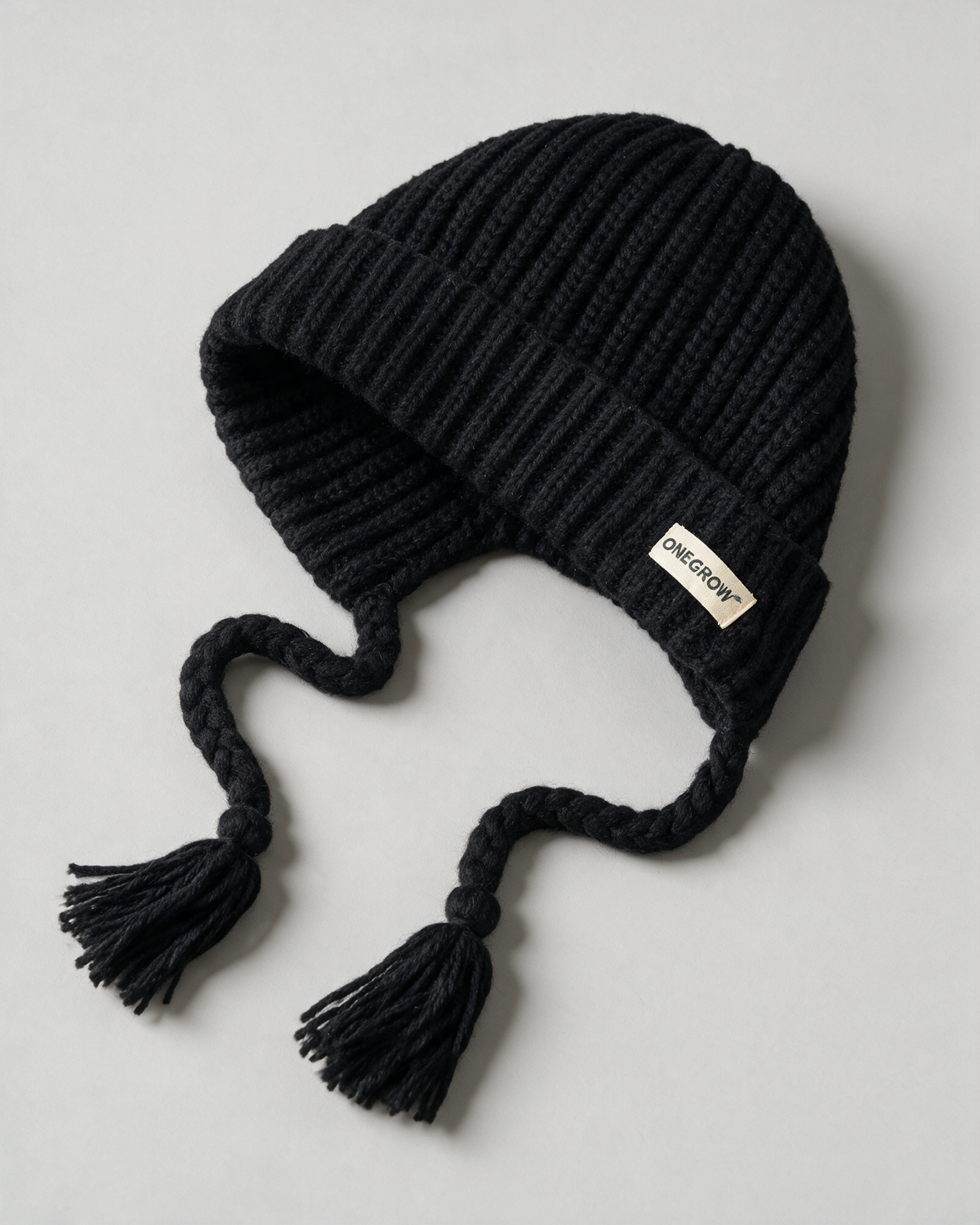 Women's knit earflap hat with braided ties — Black, product-only view