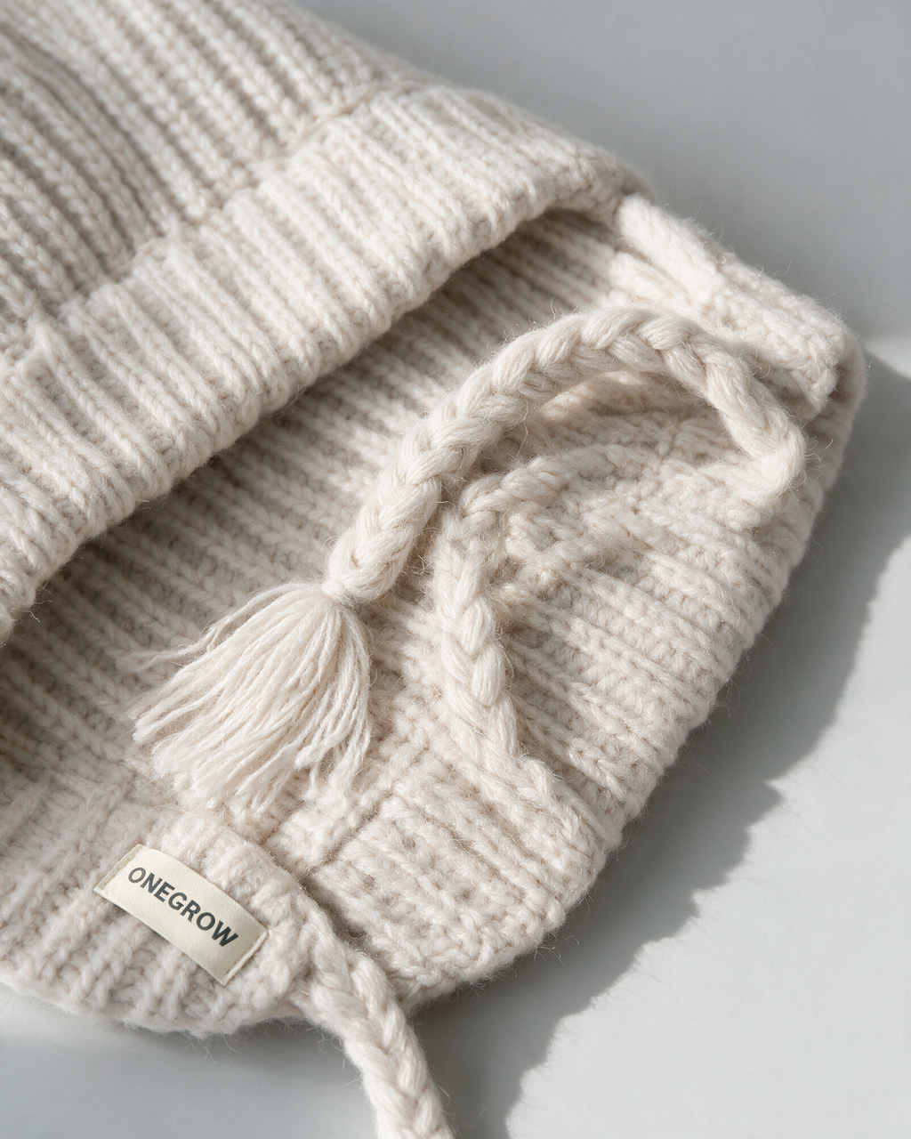 Women's knit earflap hat with braided ties — Off-White, fit and construction detail