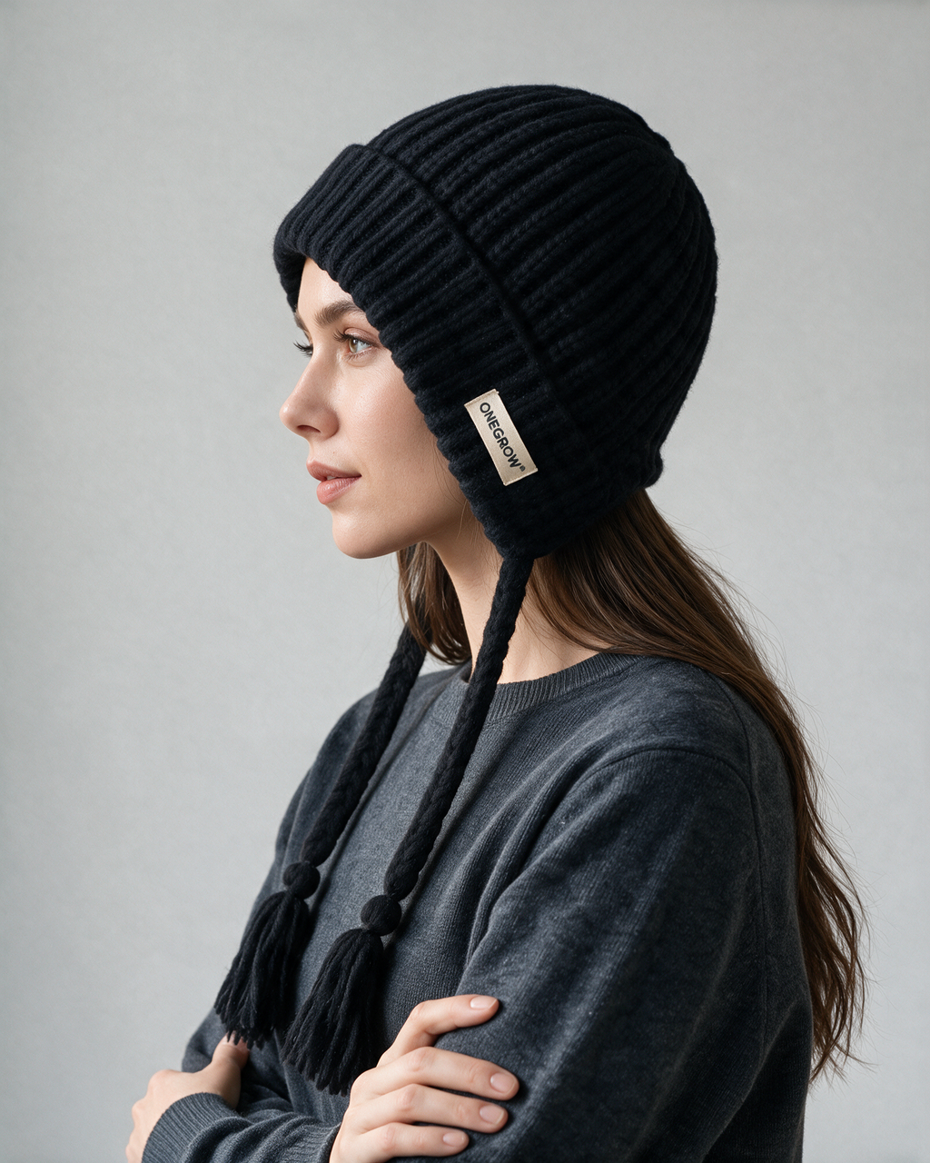 Women's knit earflap hat with braided ties — Black, on model, alternate view