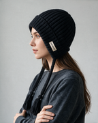 Women's knit earflap hat with braided ties — Black, on model, alternate view