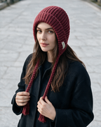 Women's knit earflap hat with braided ties — Red, on model, styled view