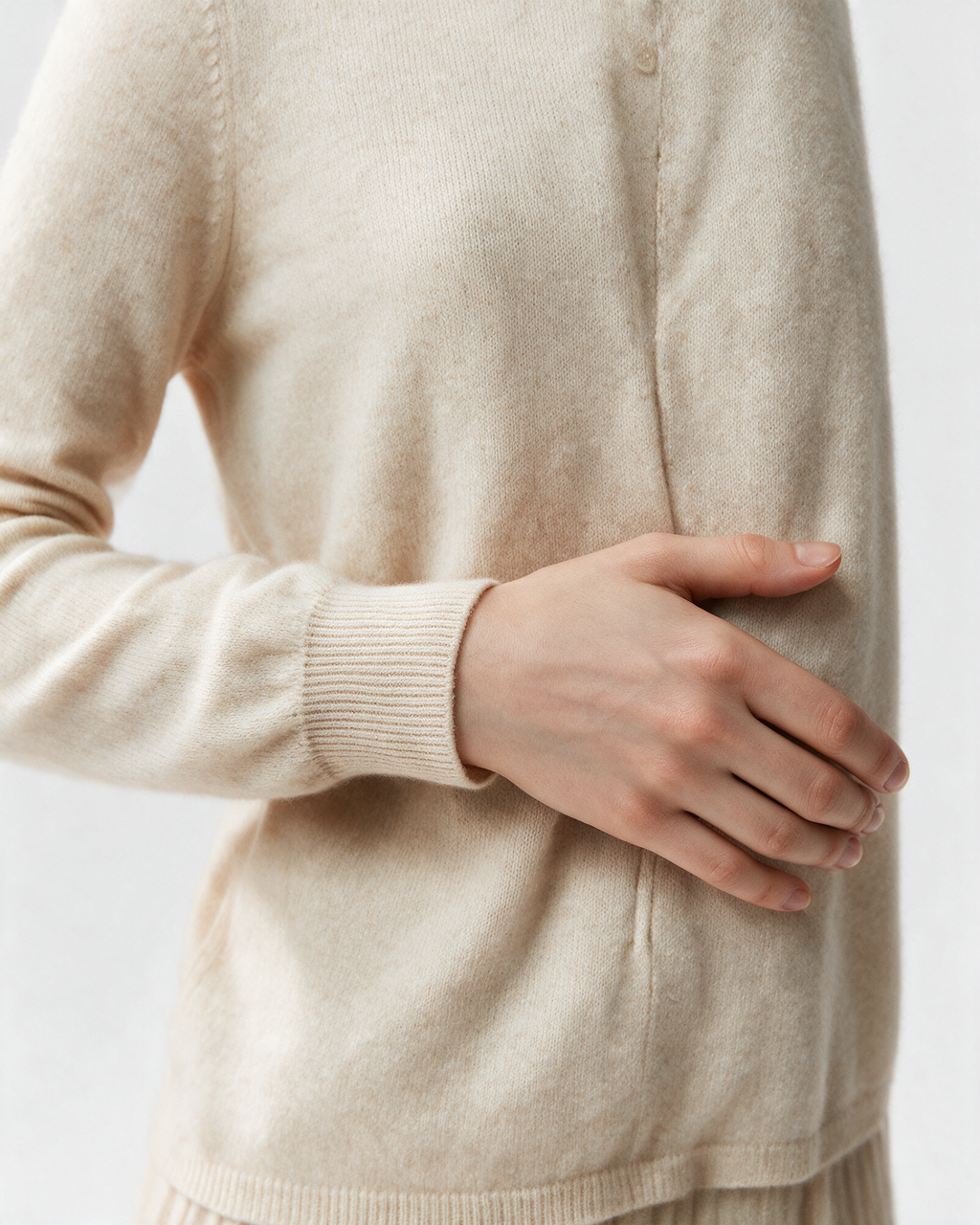 Cream button-front high-neck sweater cuff