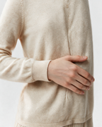 Cream button-front high-neck sweater cuff