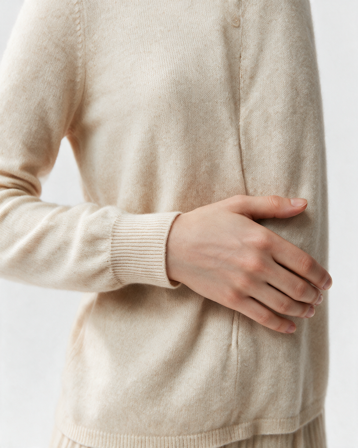 Cream button-front high-neck sweater cuff