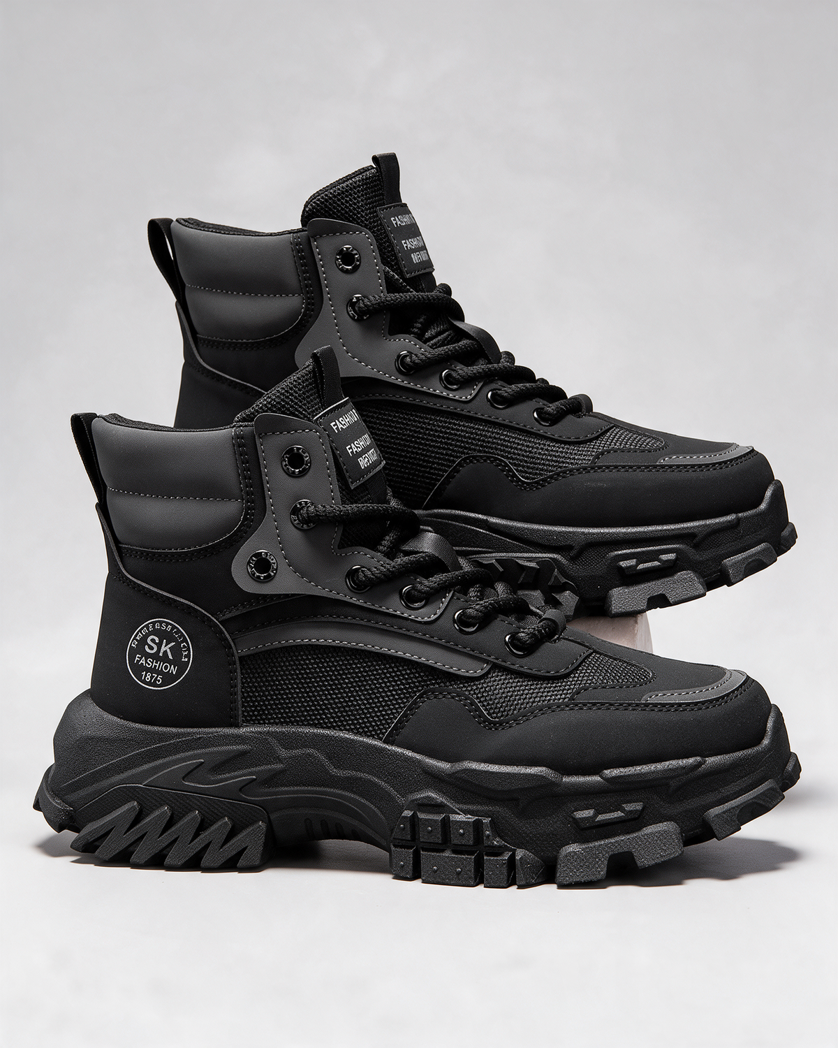 Black mesh-panel lace-up boot — construction