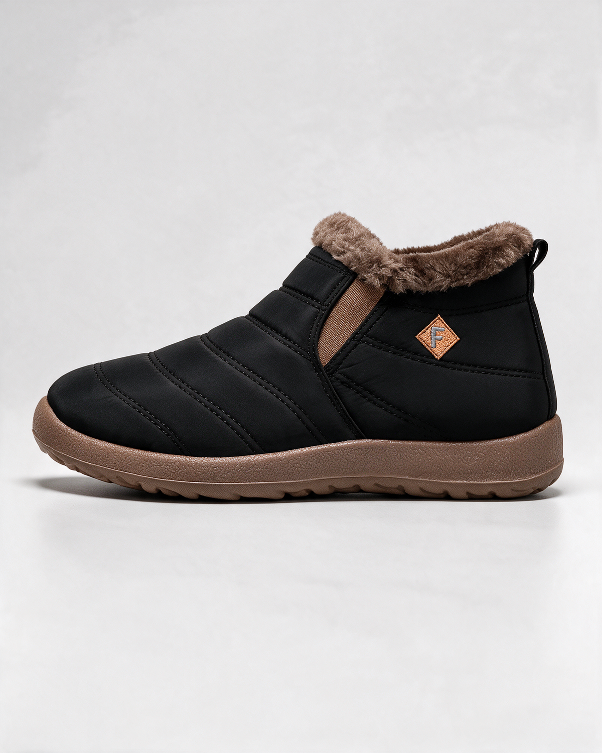 Black ankle boots with brown trim — profile