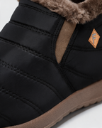 Black ankle boots with brown trim — material