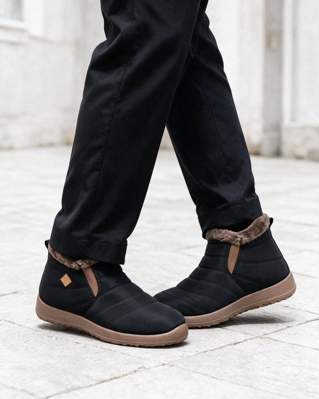 Black ankle boots with brown trim — lifestyle