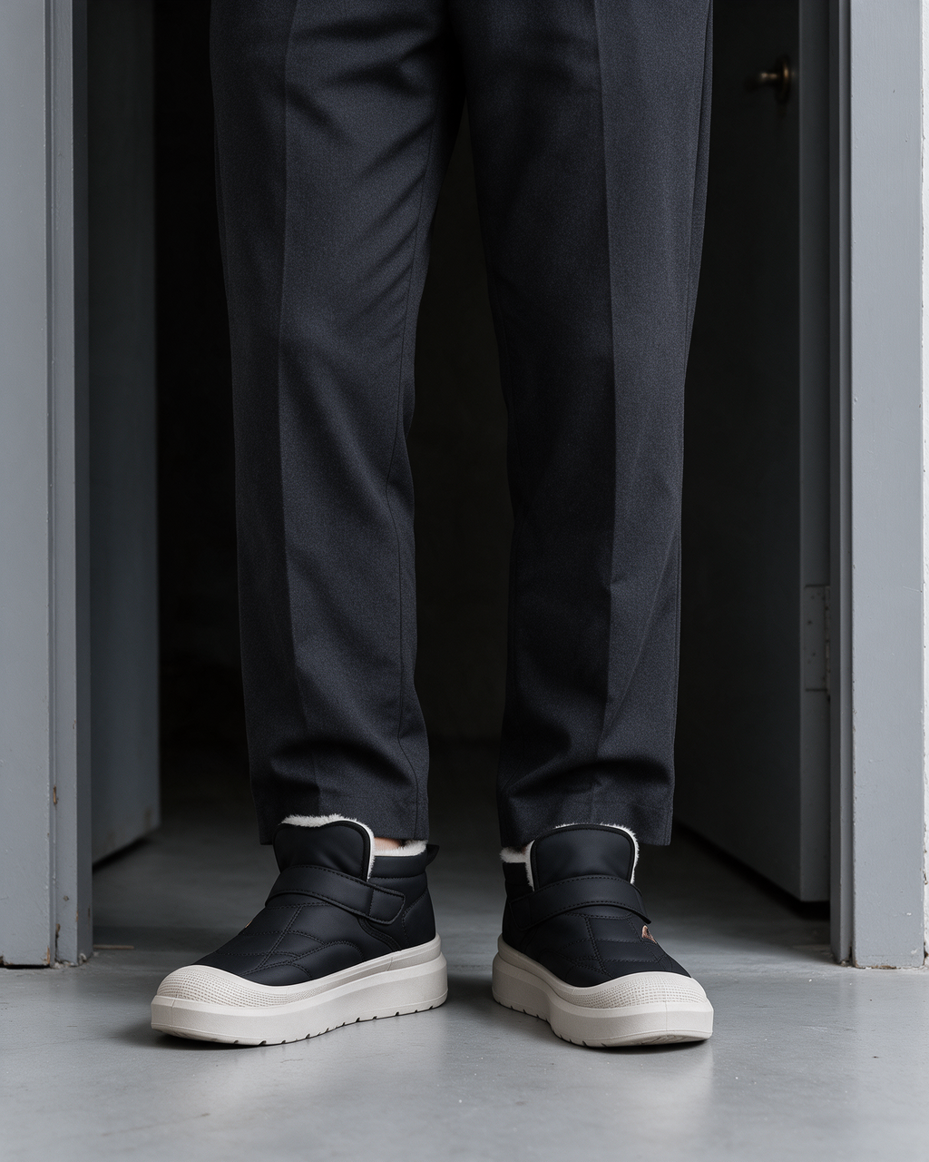 Black plush-collar strap boots, styled with dress trousers