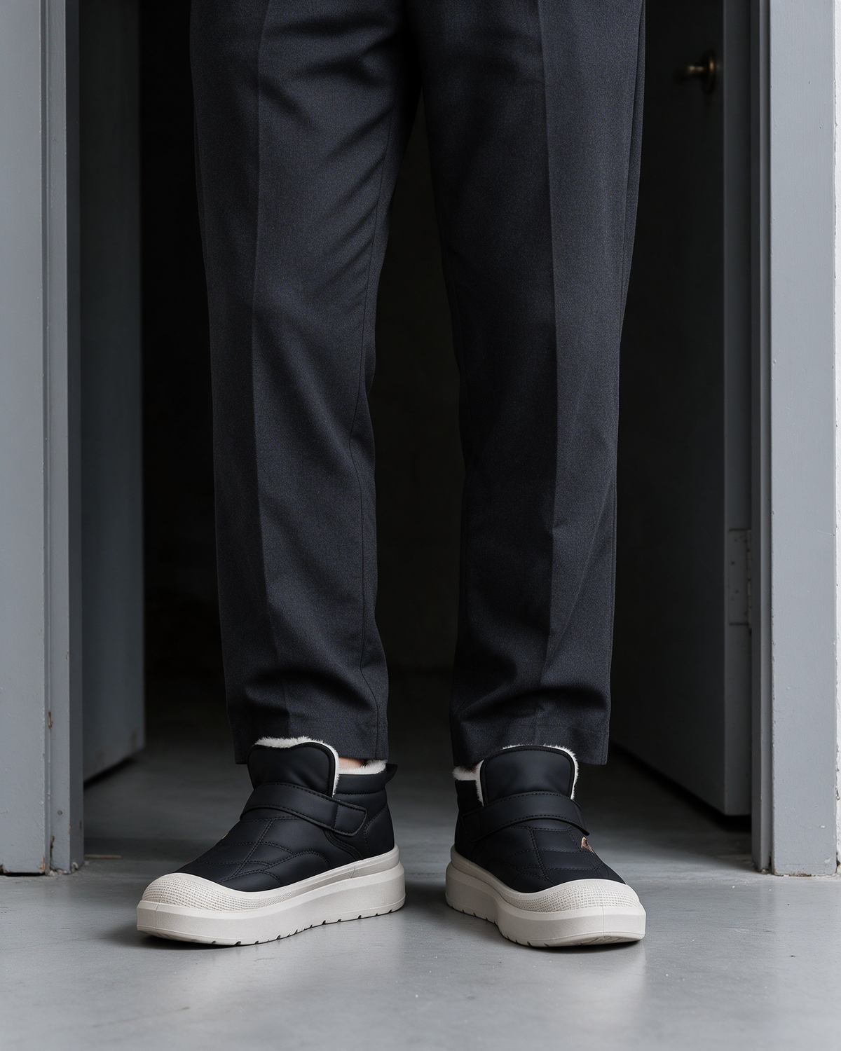 Black plush-collar strap boots, styled with dress trousers
