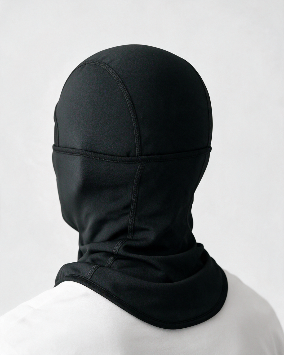 Black fleece-lined balaclava — rear view on light gray