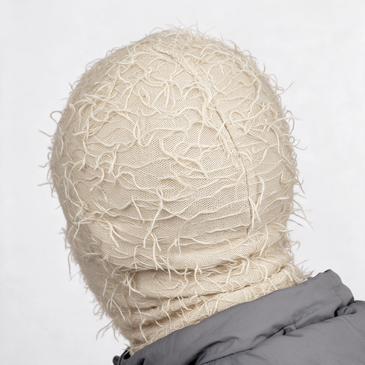 Beige distressed-knit balaclava — crown construction detail