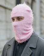 Pink distressed-knit balaclava — lifestyle portrait