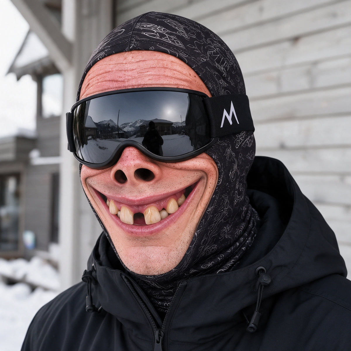 Printed fabric mask worn with ski goggles. Goggles and clothing not included.