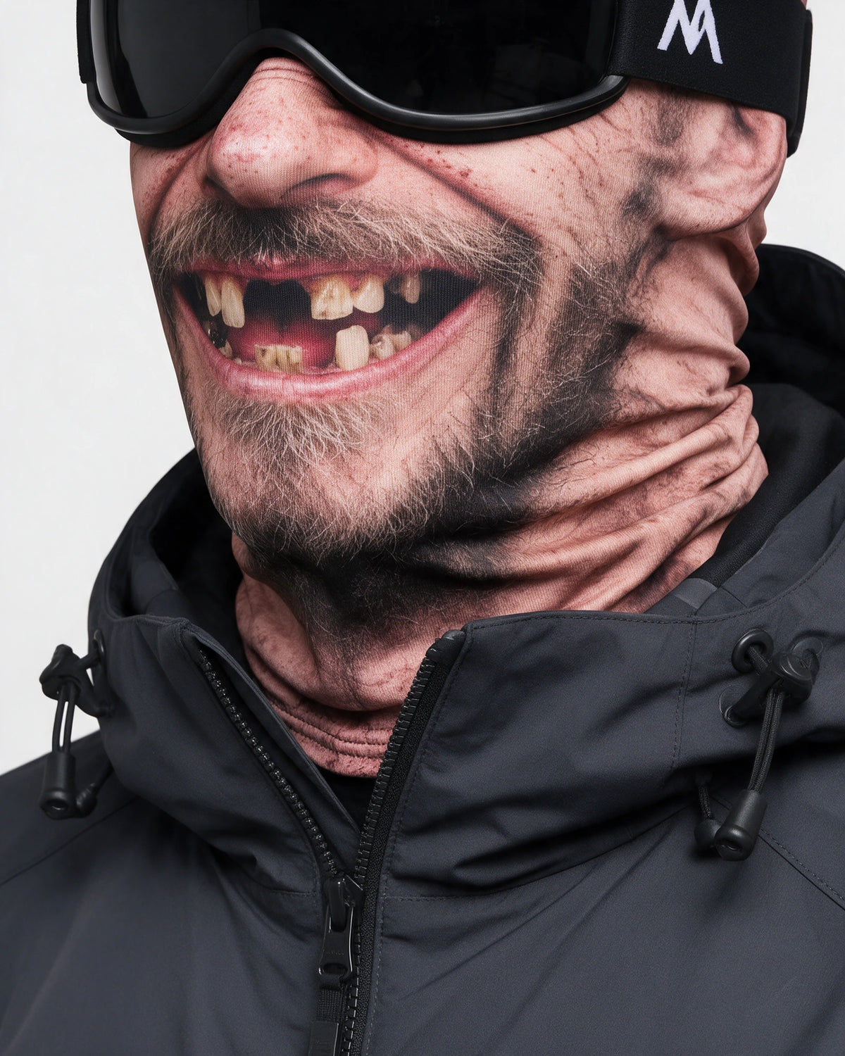 Printed fabric mask worn with ski goggles. Goggles and clothing not included.