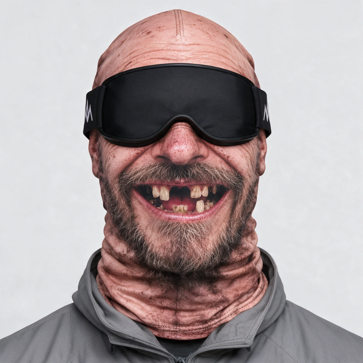 Printed fabric mask worn with ski goggles. Goggles and clothing not included.