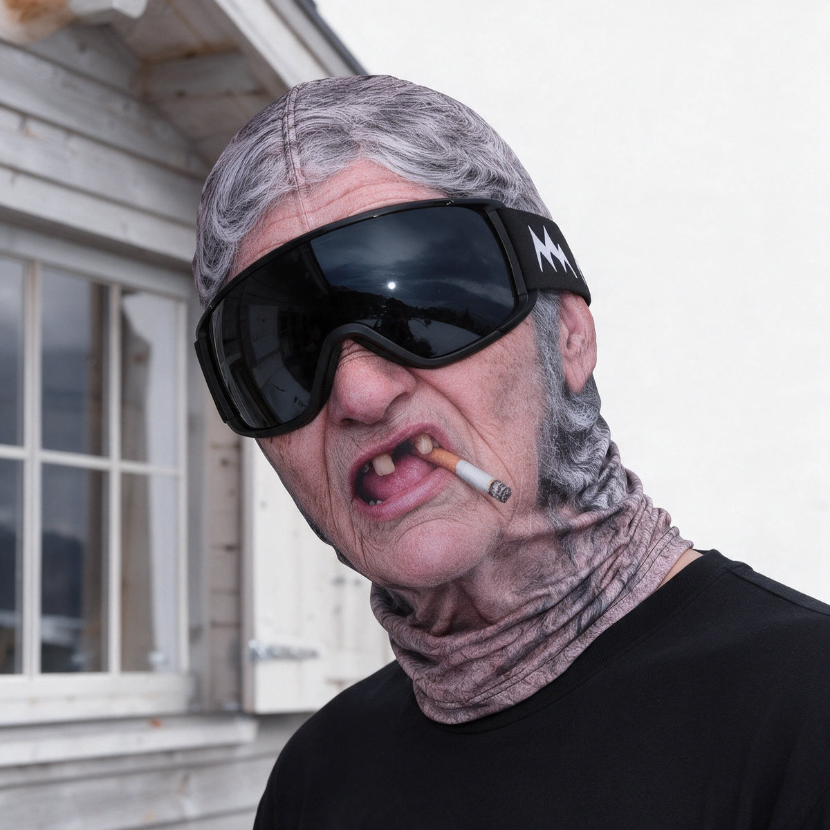Printed fabric mask worn with ski goggles. Goggles and clothing not included.