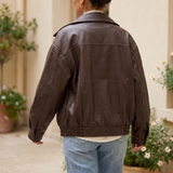 Women's Oversized Faux Leather Zip-Up Bomber Jacket — Dark Brown — rear on model