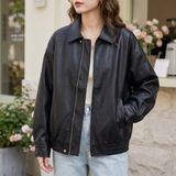 Women's Relaxed Faux Leather Bomber Jacket with Welt Pockets — Black — front on model